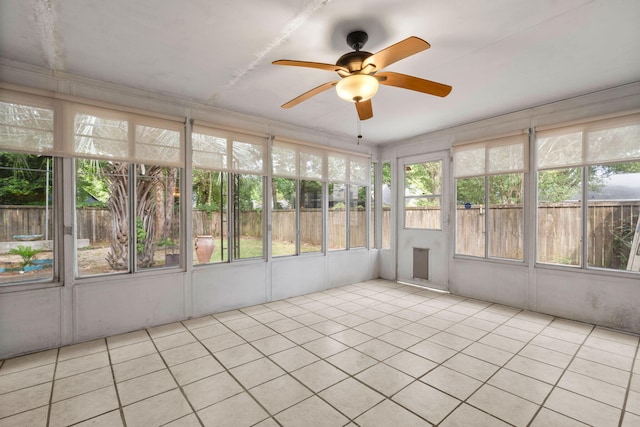 unfurnished sunroom featuring ceiling fan