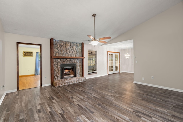 unfurnished living room with a fireplace, a ceiling fan, baseboards, vaulted ceiling, and dark wood finished floors