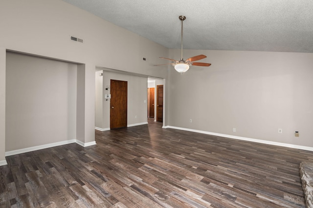 empty room with a textured ceiling, dark wood-style flooring, visible vents, and baseboards