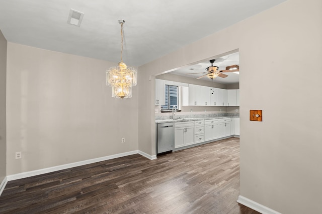 kitchen with dark wood-style floors, light countertops, white cabinetry, pendant lighting, and stainless steel dishwasher