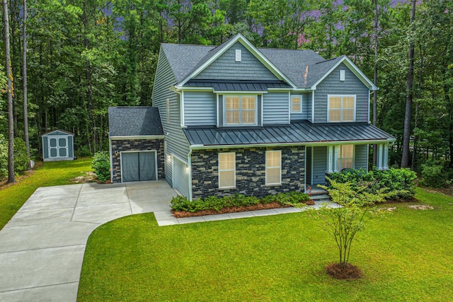 craftsman-style house with a front yard, a garage, and a storage shed