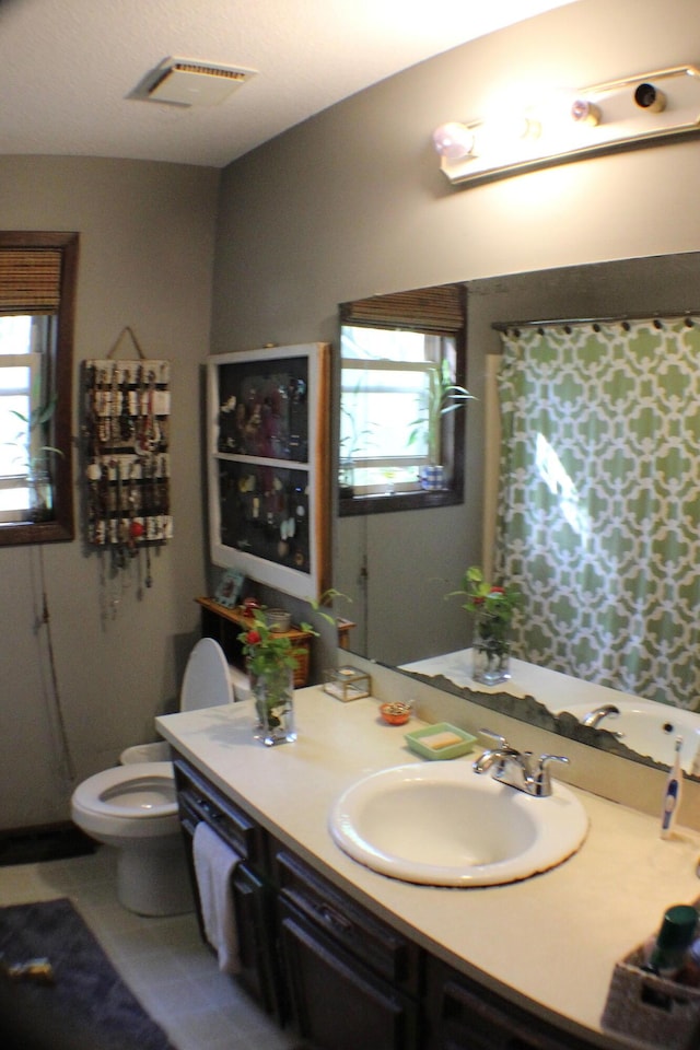 20 Anderson Ave, Charleston, SC 29412 - full bath with visible vents, toilet, plenty of natural light, and vanity