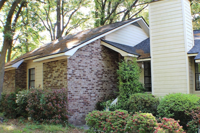 20 Anderson Ave, Charleston, SC 29412 - view of property exterior featuring brick siding, a shingled roof, and a chimney