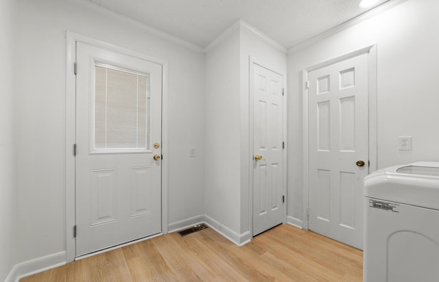 interior space featuring light wood-type flooring, washer / clothes dryer, and crown molding