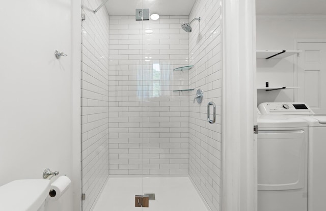 bathroom with crown molding, washer and clothes dryer, and a shower with shower door