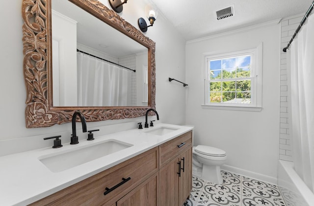 bathroom with tile patterned floors, vanity, toilet, and a textured ceiling