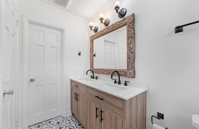 bathroom with vanity, a textured ceiling, and ornamental molding