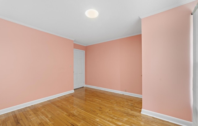 unfurnished room with hardwood / wood-style flooring and crown molding