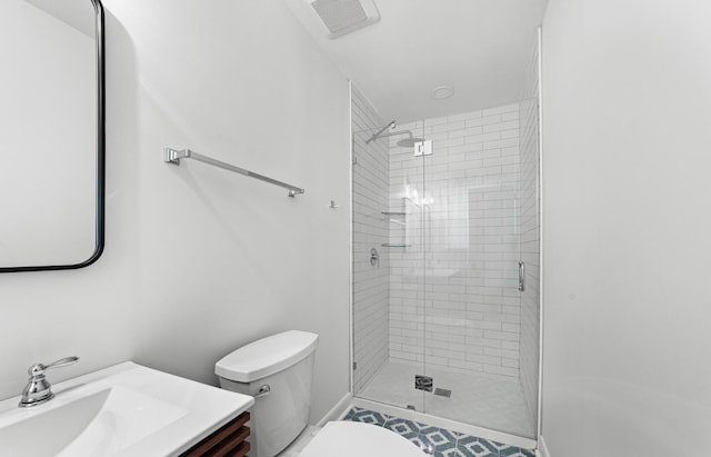 bathroom featuring tile patterned flooring, vanity, toilet, and walk in shower