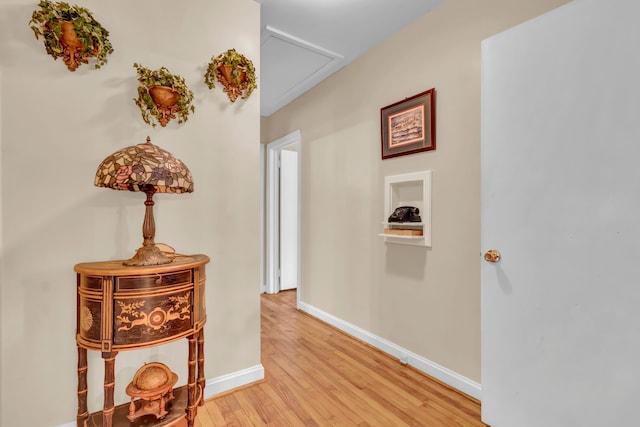 corridor with light hardwood / wood-style floors