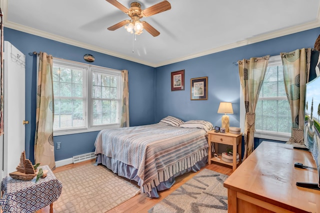 bedroom with multiple windows, crown molding, ceiling fan, and light wood-type flooring