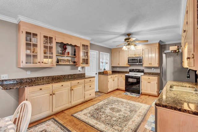 kitchen featuring dark stone countertops, sink, electric range, and light hardwood / wood-style floors