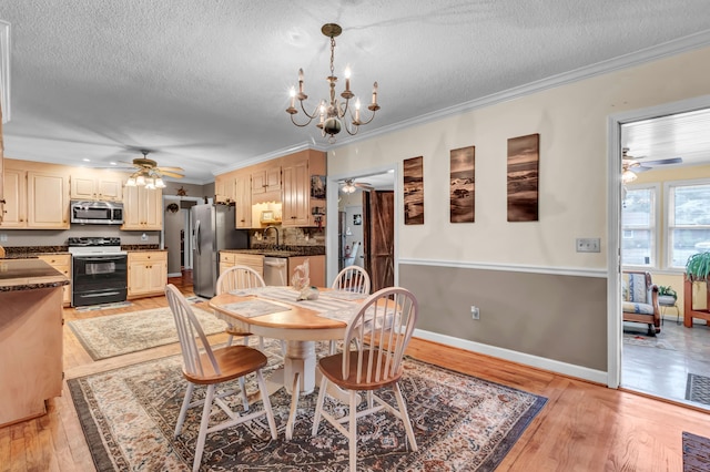 dining room with ceiling fan with notable chandelier, sink, ornamental molding, light hardwood / wood-style floors, and a textured ceiling