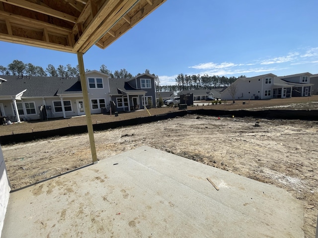 view of yard with a residential view and a patio area