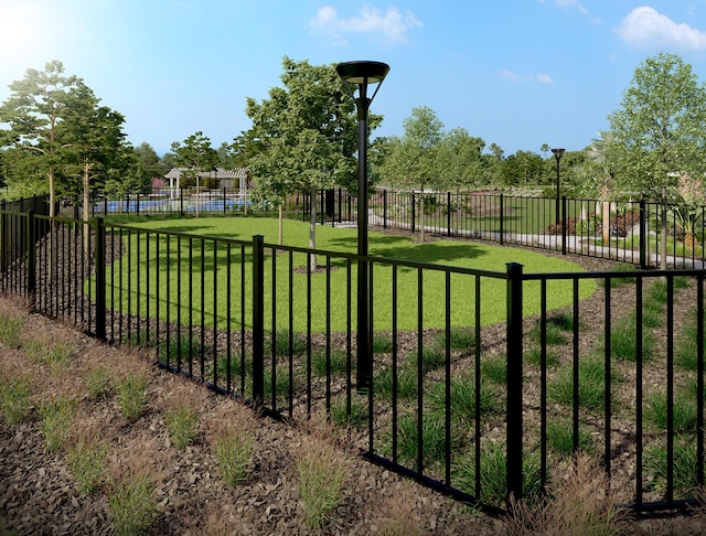 view of gate featuring a yard and fence