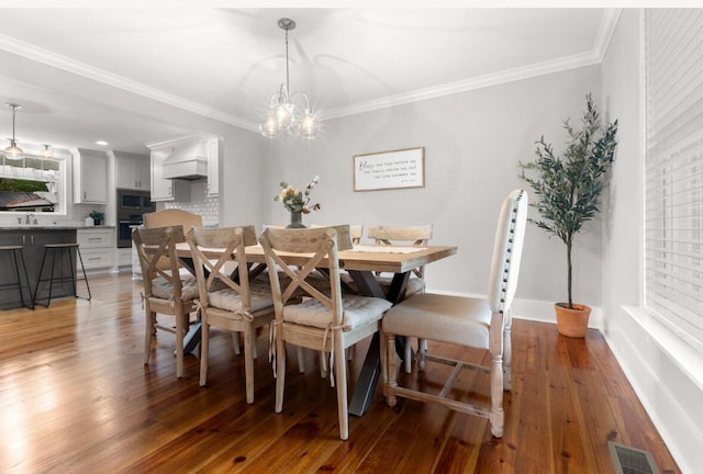 1211 Dennis Blvd, Moncks Corner, SC 29461 - dining area featuring light wood-type flooring, crown molding, and a chandelier