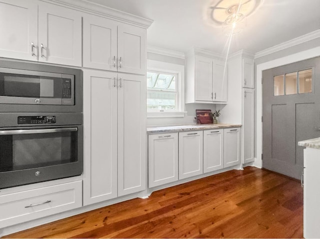 1211 Dennis Blvd, Moncks Corner, SC 29461 - kitchen featuring appliances with stainless steel finishes, crown molding, dark wood-type flooring, and white cabinets