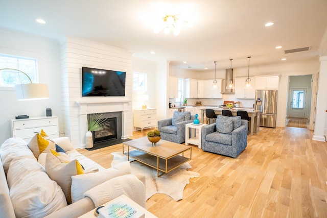 3707 Gambrill Ln, Mount Pleasant, SC 29466 - living area featuring light wood-style flooring, a brick fireplace, and recessed lighting