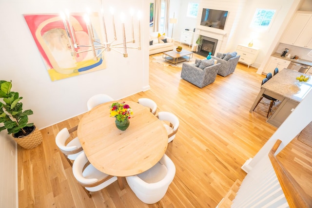 3707 Gambrill Ln, Mount Pleasant, SC 29466 - dining space with light wood-style floors and a fireplace with flush hearth