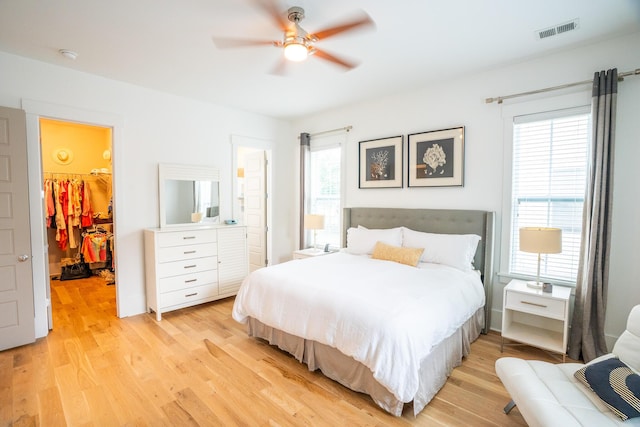 3707 Gambrill Ln, Mount Pleasant, SC 29466 - bedroom with light wood-style flooring, multiple windows, a walk in closet, and ceiling fan