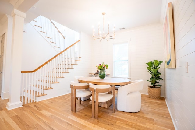 3707 Gambrill Ln, Mount Pleasant, SC 29466 - dining room with stairway, light wood-style flooring, a chandelier, and decorative columns