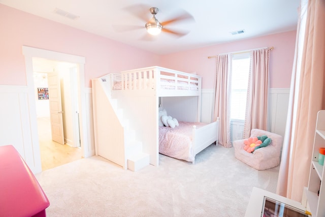3707 Gambrill Ln, Mount Pleasant, SC 29466 - carpeted bedroom with wainscoting, a ceiling fan, and a decorative wall