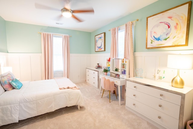 3707 Gambrill Ln, Mount Pleasant, SC 29466 - bedroom with wainscoting, multiple windows, a decorative wall, light colored carpet, and a ceiling fan
