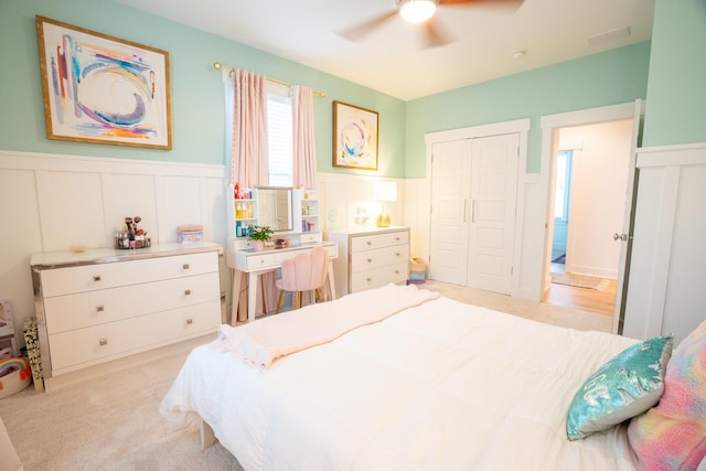 3707 Gambrill Ln, Mount Pleasant, SC 29466 - bedroom with a decorative wall, wainscoting, a closet, ceiling fan, and light carpet