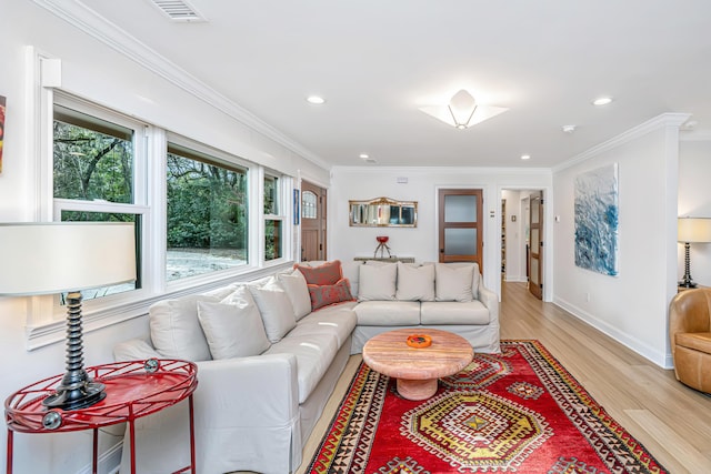 living area featuring baseboards, visible vents, crown molding, light wood-style floors, and recessed lighting