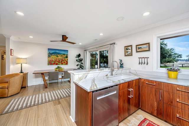 kitchen featuring light wood finished floors, ornamental molding, light stone countertops, stainless steel dishwasher, and a sink