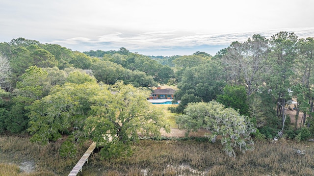 birds eye view of property featuring a view of trees