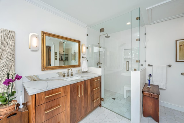 full bathroom with baseboards, a stall shower, vanity, and crown molding