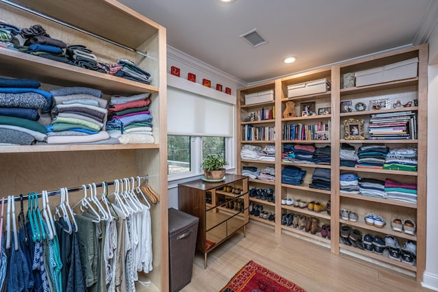 walk in closet with wood finished floors and visible vents