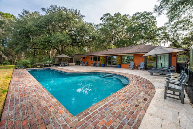 pool with a patio and a gazebo