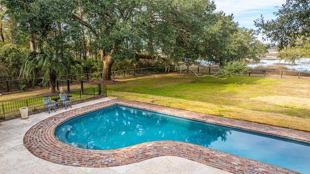 view of swimming pool featuring a fenced backyard, a patio, a fenced in pool, and a yard