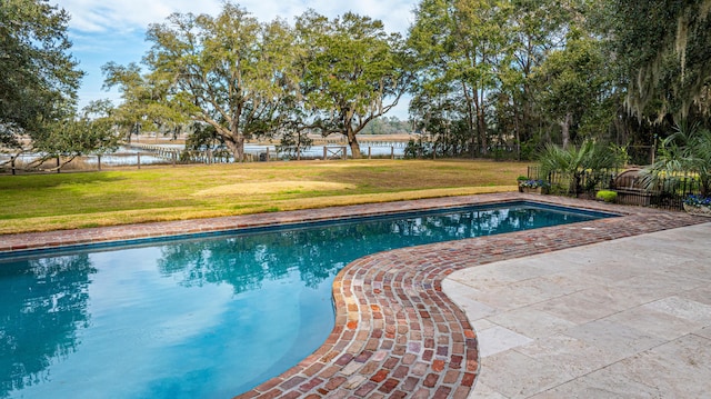 view of swimming pool with a water view, a fenced in pool, fence, and a lawn