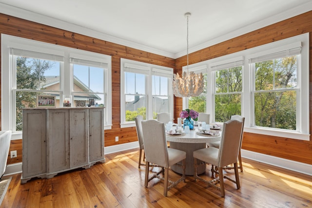 sunroom / solarium with a notable chandelier