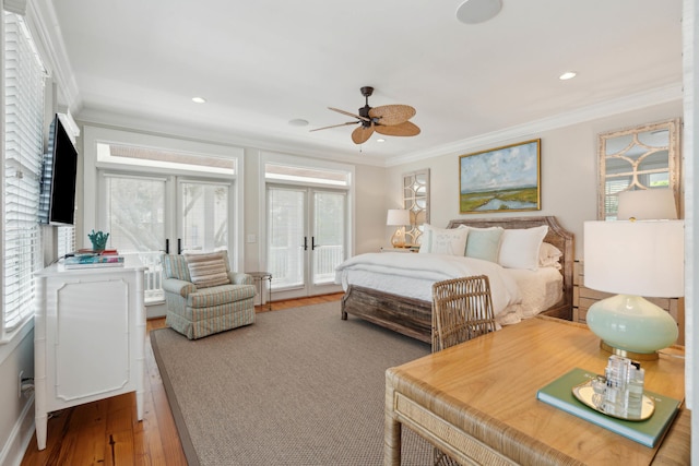bedroom with crown molding, wood finished floors, multiple windows, access to outside, and french doors