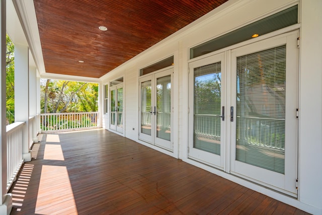 wooden terrace featuring french doors and covered porch
