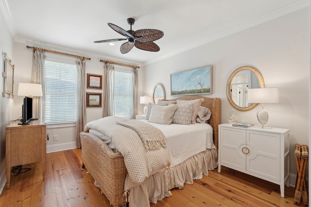 bedroom featuring crown molding, baseboards, and light wood-style floors