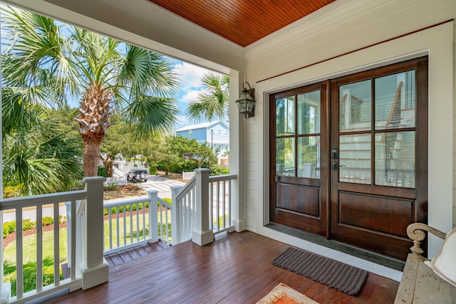 exterior space featuring covered porch and french doors