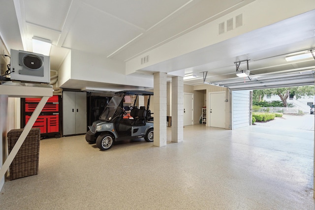 garage with visible vents and a garage door opener