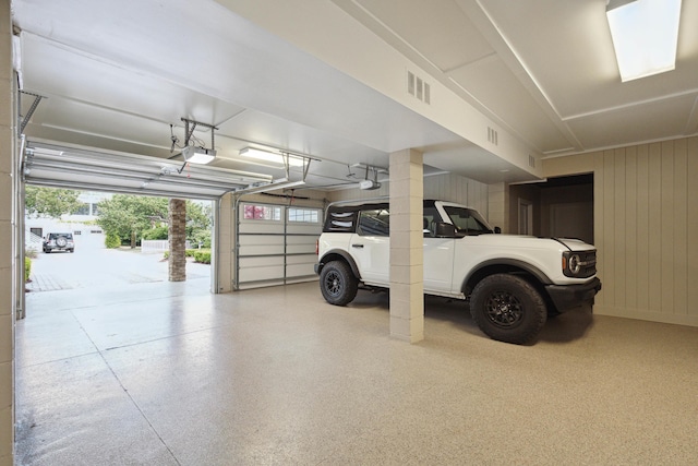 garage with visible vents and a garage door opener