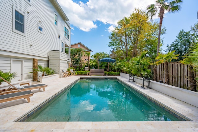view of pool with a fenced in pool, fence, and a patio