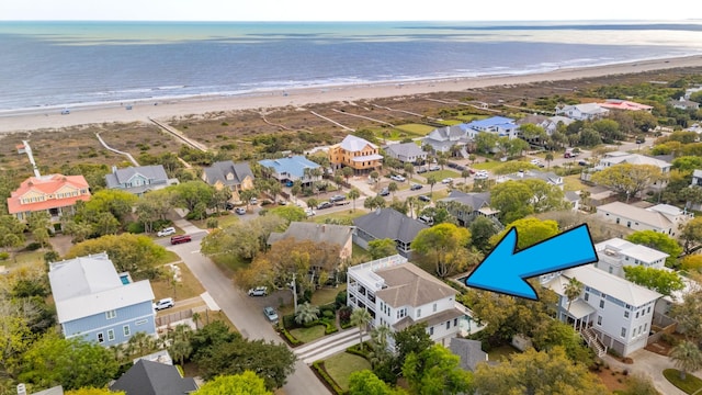 aerial view featuring a water view, a beach view, and a residential view