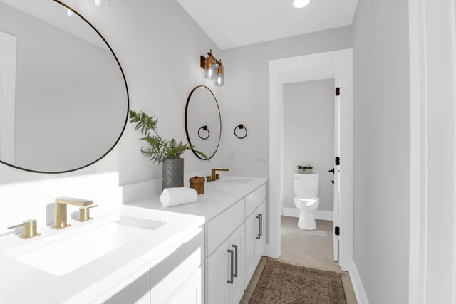 397 Parkdale Dr, Charleston, SC 29414 - bathroom featuring double vanity, toilet, and baseboards