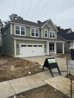 traditional-style house with an attached garage and driveway