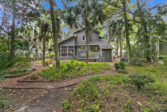 back of property featuring a sunroom and a wooden deck