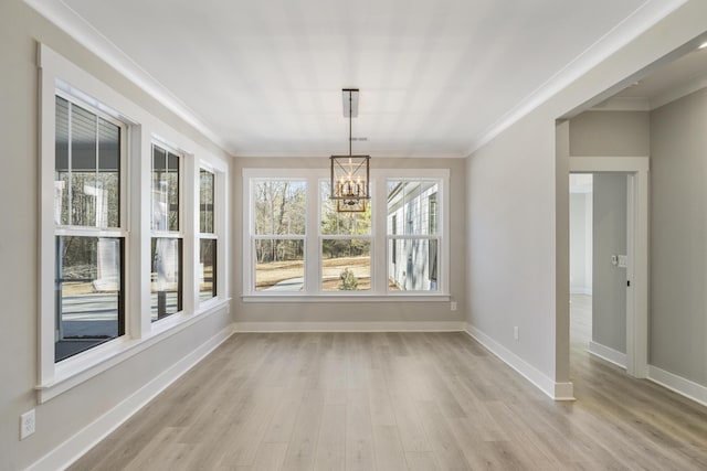 unfurnished sunroom featuring a chandelier