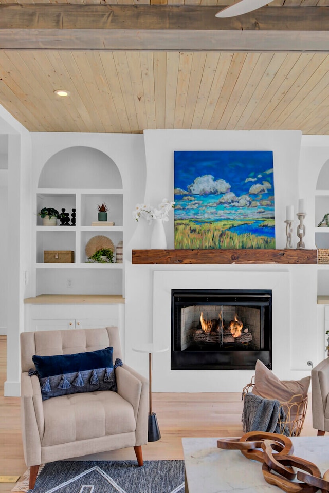 living room featuring built in shelves, wooden ceiling, wood-type flooring, and beamed ceiling